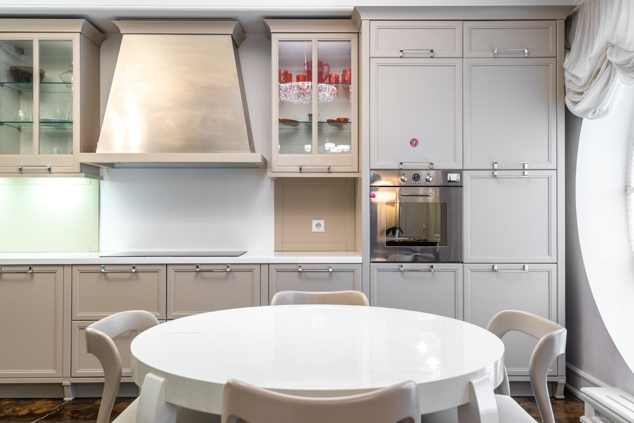 Contemporary kitchen with sleek cabinets and a round dining table.